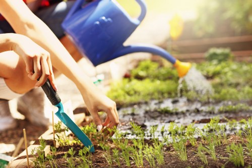 Community gardener working in a Wanstead front garden, tools visible